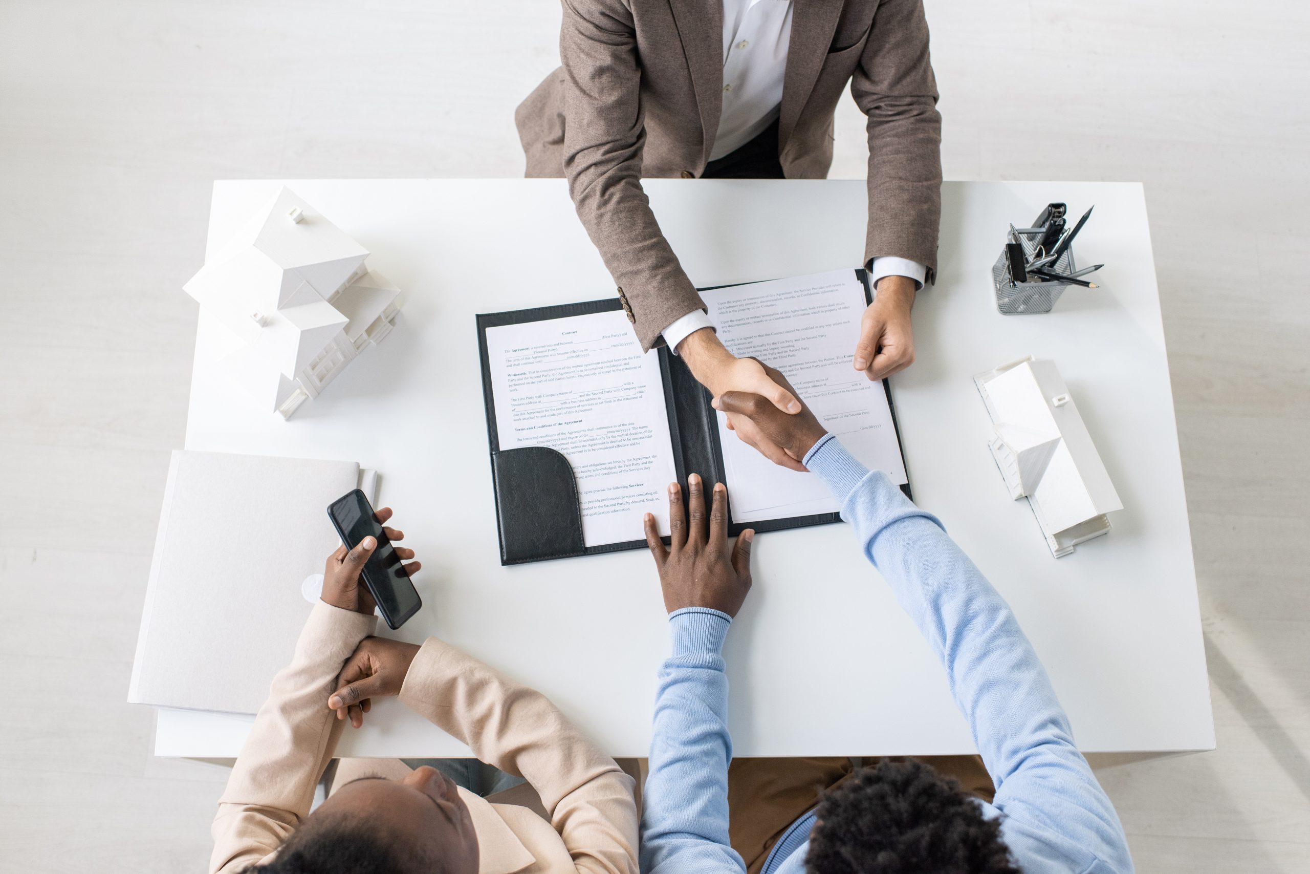 Overview of handshake of lawyer and client after negotiation