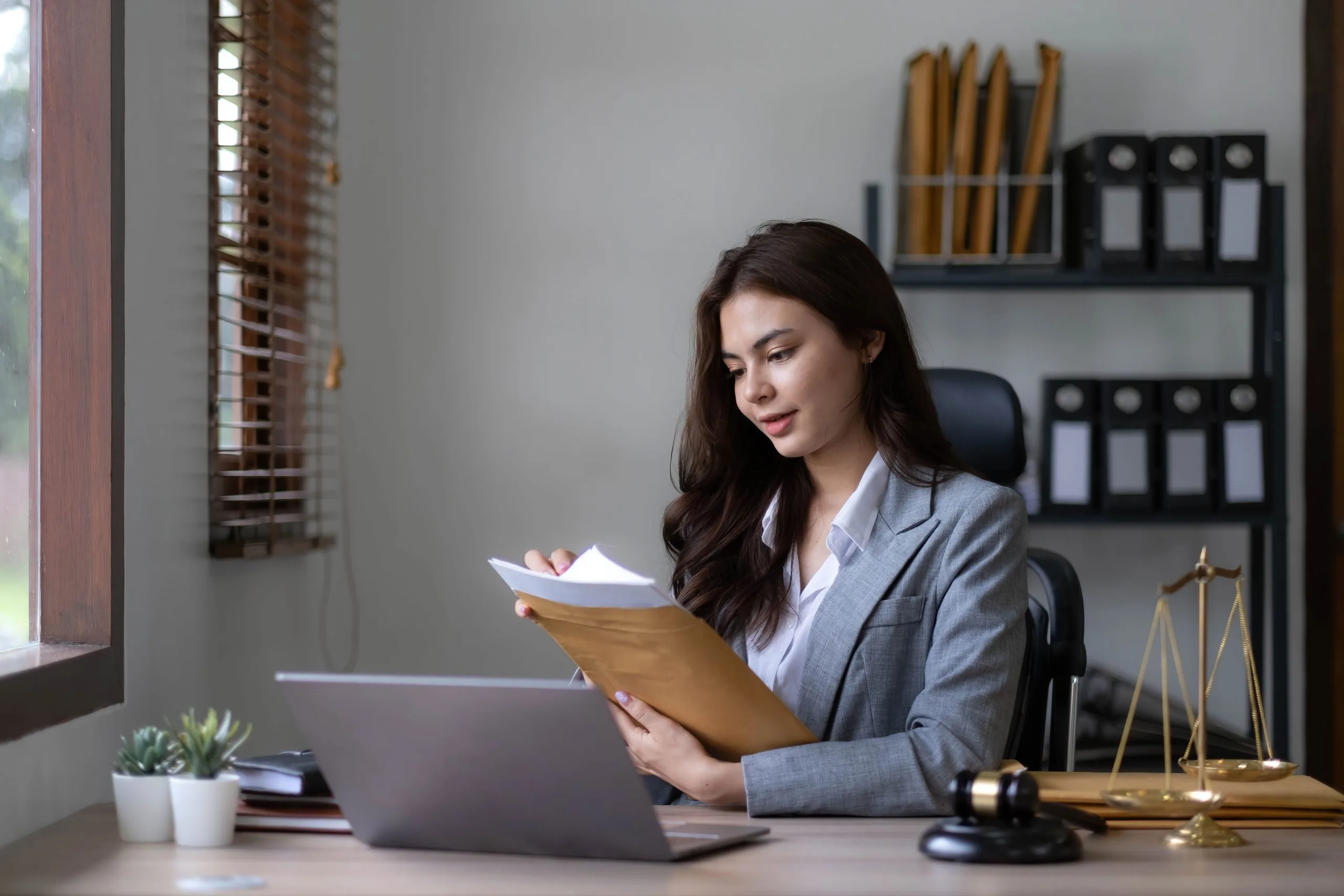 asian-lawyer-woman-working-with-a-laptop-computer-2022-10-24-23-42-44-utc-scaled